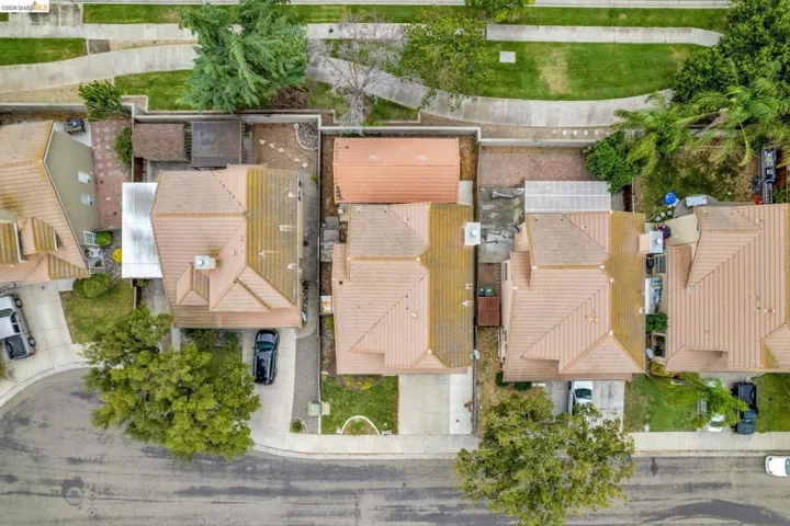 Aerial perspective showcasing multiple residential properties with terracotta-style tile roofing