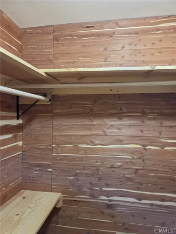 primary bedroom walk in ceder wood closet