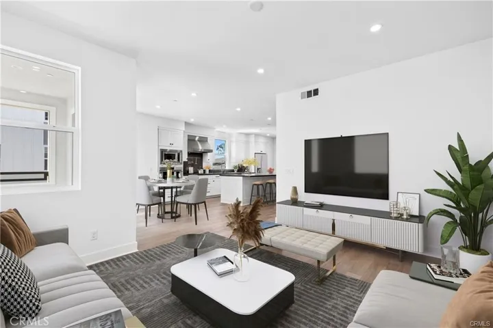 This view is looking from the living room back to the kitchen and dining area.