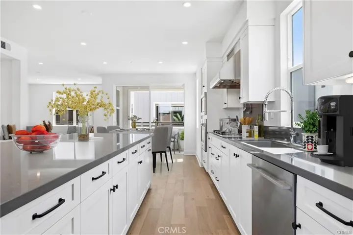 A view of the kitchen & dining area, then there is an outside covered patio just beyond the sliding glass doors.