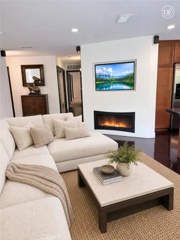 Living area, fireplace, TV with virtual staging