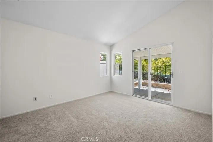 There is a sliding glass door from the primary bedroom to the backyard with views of the many trees!