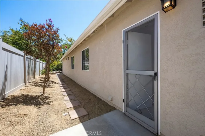 Side yard #2, the newer vinyl fence and the side entrance into the garage.