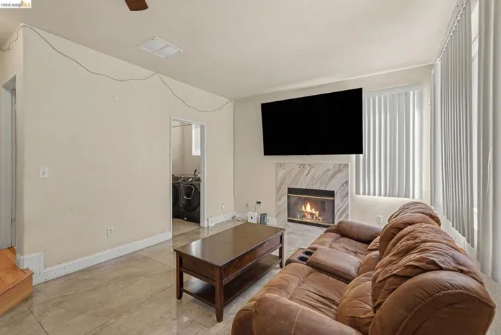 Living area with tiled flooring and a marble-surround fireplace