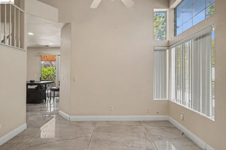 High ceilings with a prominent corner window arrangement, offering abundant natural illumination