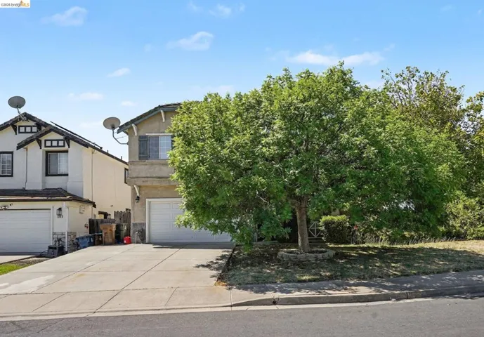 Two-story residence with an integrated garage and a wide driveway