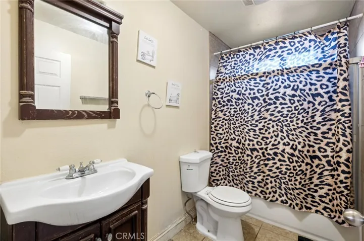 Downstairs full bathroom with shower over tub