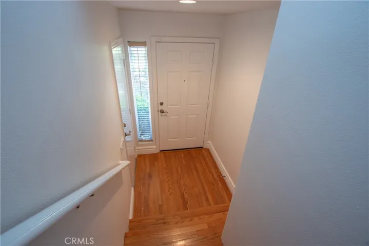 Inside entry with side lite wood floor.
