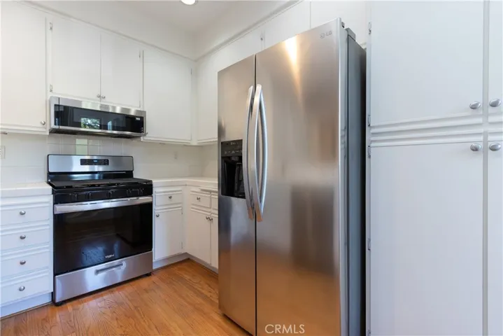 Stainless steel refrigerator, range and microwave.