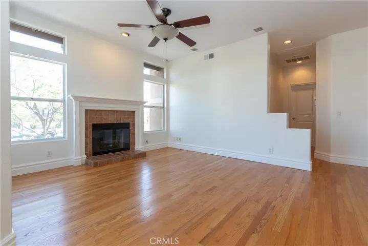 Charming fireplace and a ceiling fan.
