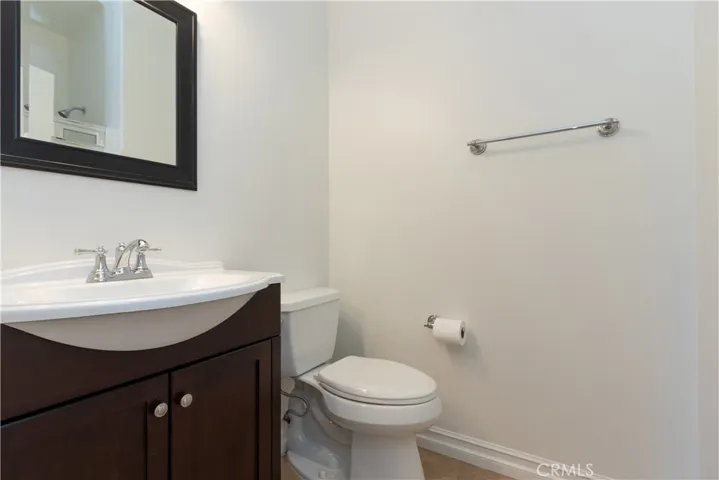 Hall bath with handsome vanity and glass enclosed shower.