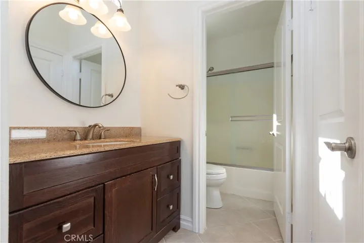 Generous vanity in the primary bath, with separate water closet/shower & bath room. Walk-in closet to the right.