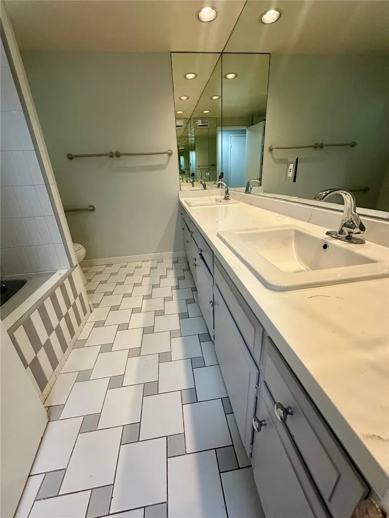 Newly updated hallway bathroom. Double sink and bathtub