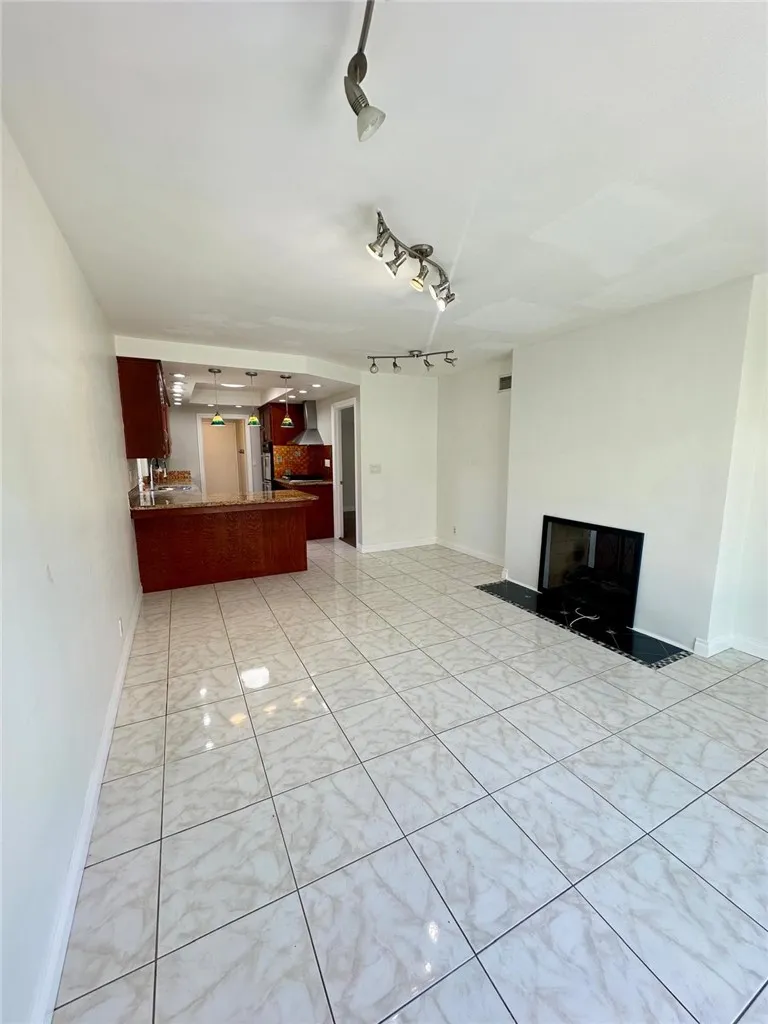 Another view of the family room with a cozy fireplace
