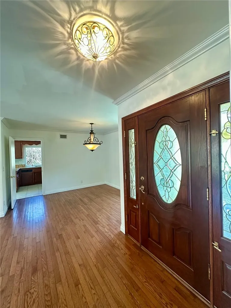 View of front door and the dining area, with the kitchen entry in the back