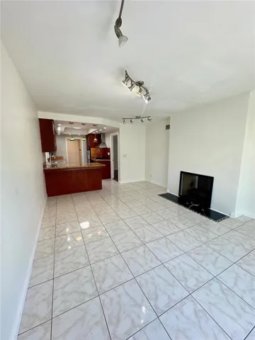 Another view of the family room with a cozy fireplace