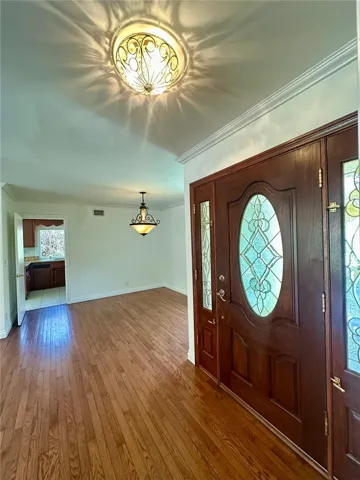 View of front door and the dining area, with the kitchen entry in the back