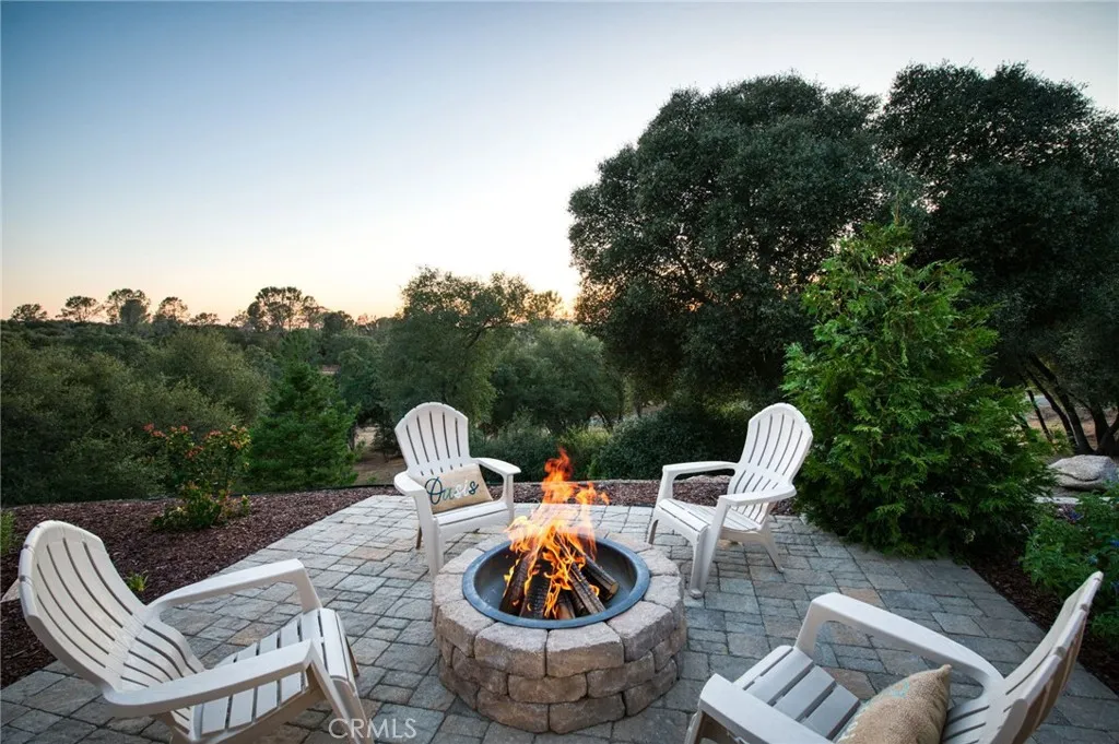 Custom paved fire pit area offering breathtaking sunset and mountain views—the perfect spot for evening relaxation.