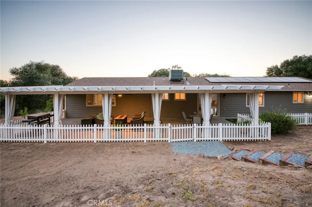 Charming and relaxing covered patio with clean white railings, epitomizing classic country living.
