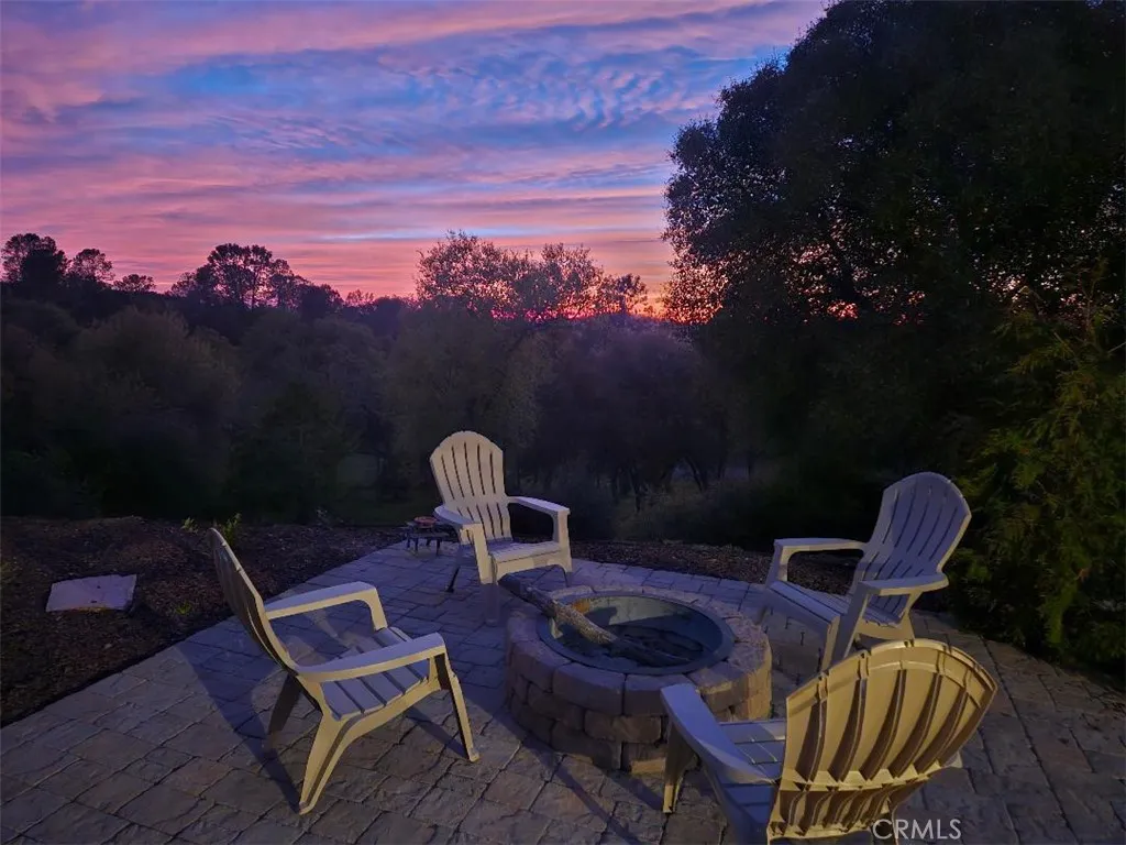 Unrivaled Sierra foothill sunsets over your private 2.7-acre estate, viewed directly from the custom-paved fire pit patio.