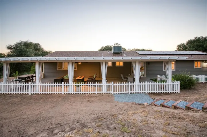 Charming and relaxing covered patio with clean white railings, epitomizing classic country living.