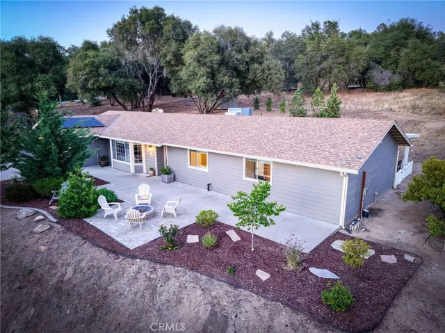 Elevated drone view showcasing the expansive roofline, low-maintenance landscaping, and seamless indoor-outdoor layout.