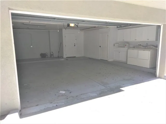 Extra large 2 car garage with additional closet, wall cabinets,  workshop area and washer/Dryer
