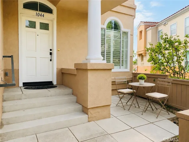 Grand Entrance To Your Home! End Unit With Room To Relax On The Patio! (Bistro set virtually staged to show potential only. Not included with rent)