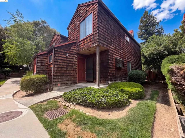 Two-story residence featuring wood shingle siding and a prominent front entry
