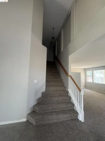 Stairs featuring baseboards and carpet