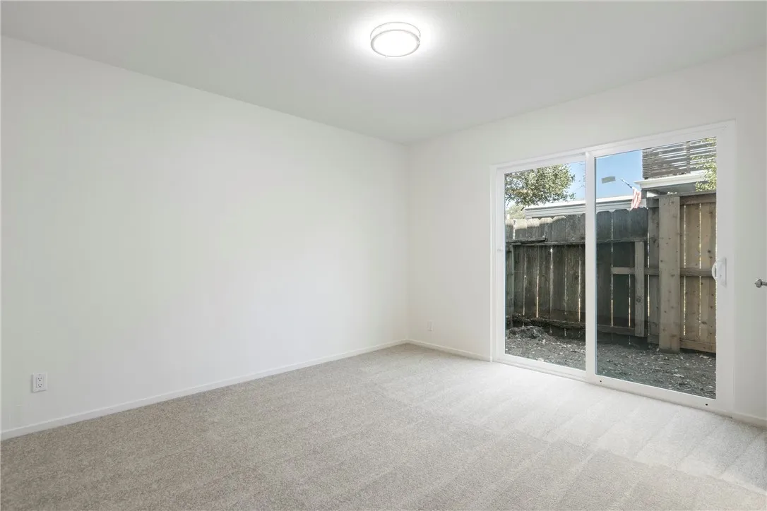 Downstairs bedroom to the left with sliding glass door.
