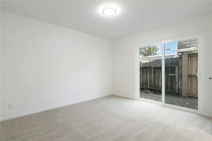 Downstairs bedroom to the left with sliding glass door.