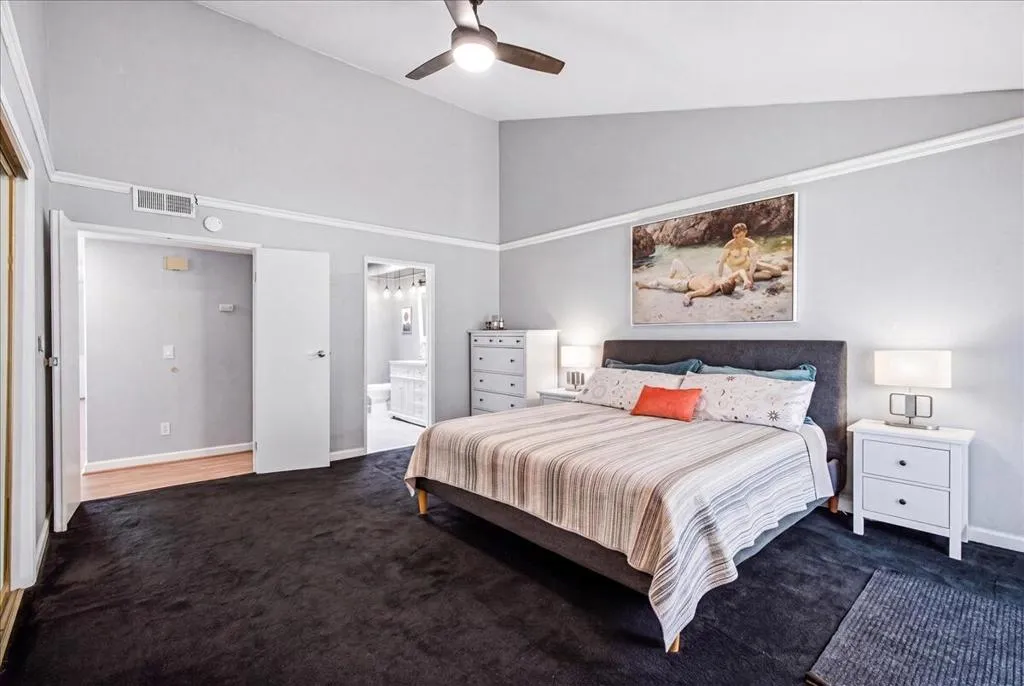 Primary bedroom w vaulted ceilings
