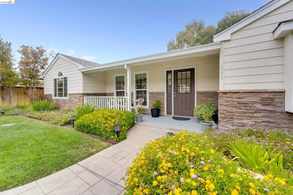 Exterior facade featuring horizontal siding and stone veneer accents