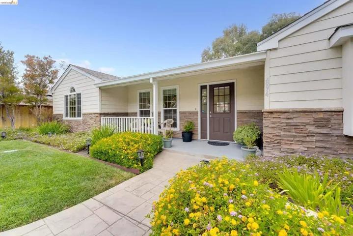 Exterior facade featuring horizontal siding and stone veneer accents