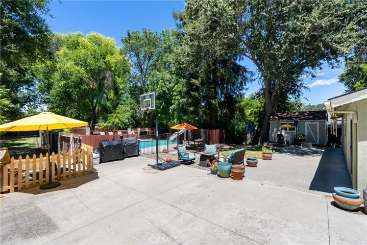 The backyard features an extended concrete patio perfect for entertaining or relaxing.