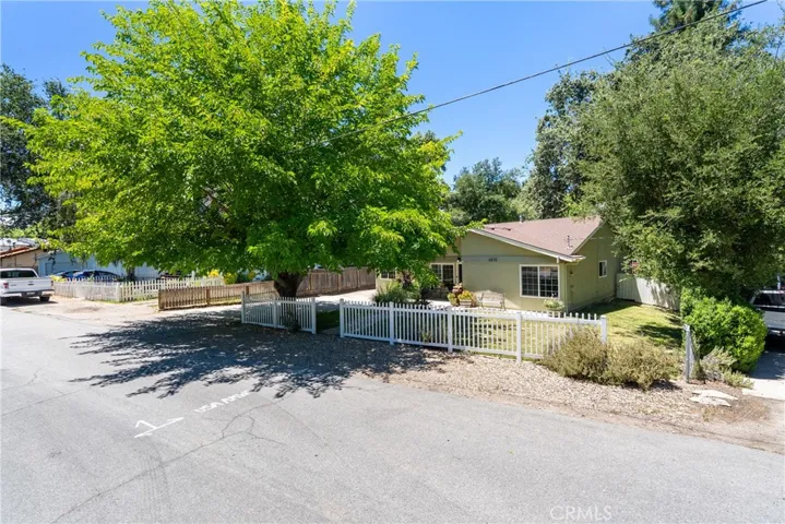 As you pull up to the home you'll notice the charming white picket fence and extra parking.