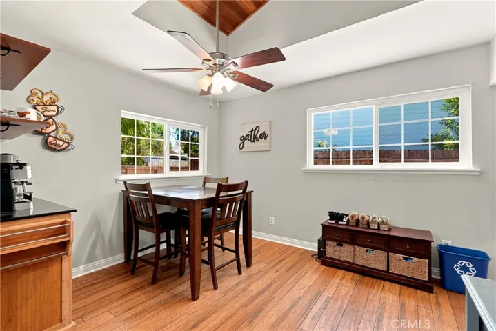 Next to the kitchen is the dining area with multiple windows that bring in the natural light.