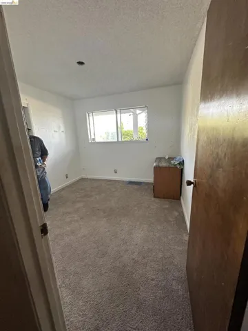Room featuring light-colored wall paint and textured ceiling