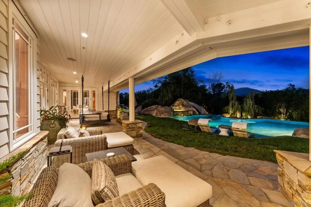 The outdoor living room equipped with everything you need for year around entertaining. Build in outdoor heaters, TV, all doors in the great room and kitchen open to the outdoors
