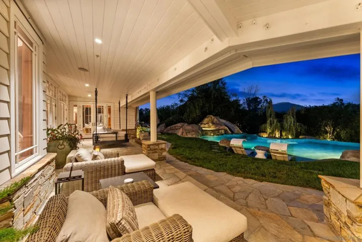 The outdoor living room equipped with everything you need for year around entertaining. Build in outdoor heaters, TV, all doors in the great room and kitchen open to the outdoors