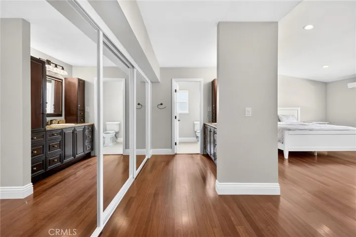 Expansive wall-to-wall mirrored closet doors enhance the room’s open feel.
