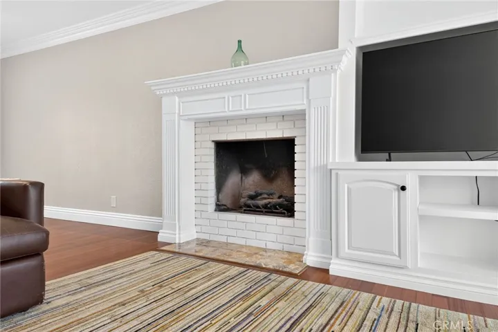 Fireplace and mantle create a warm focal point within the room.
