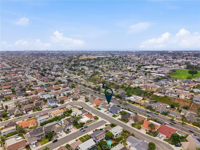 Drone angle capturing the property’s two-story footprint and surrounding homes.
