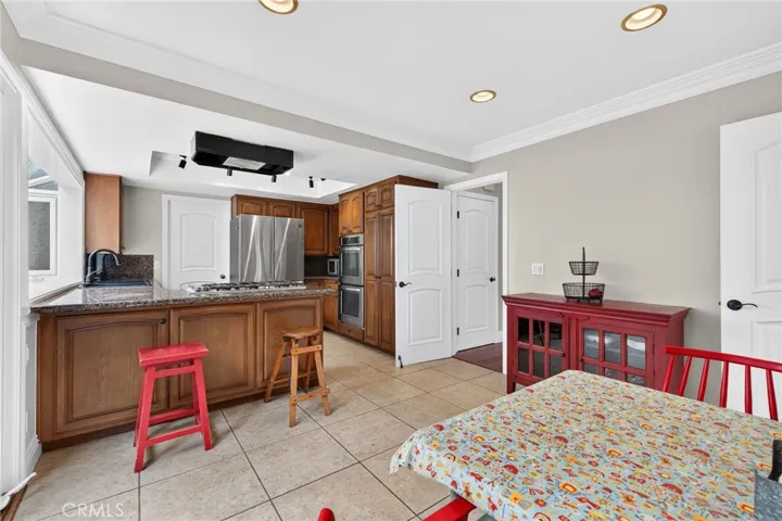 Recessed lighting brightens the kitchen and surrounding areas.
