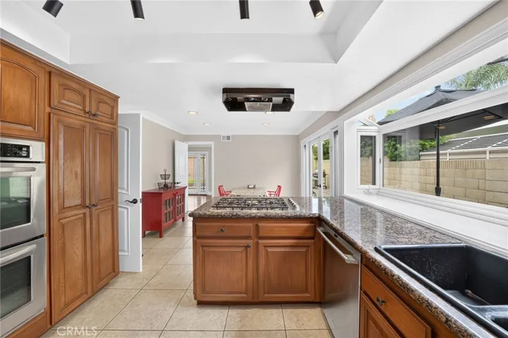 Spacious kitchen with granite countertops and rich wood cabinetry.
