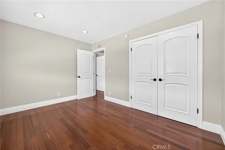 Large bedroom includes expansive closet space and natural light.