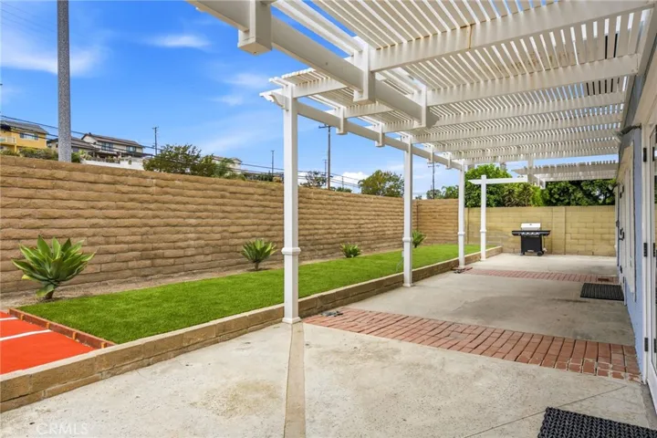 Covered aluminum patio area creates a comfortable setting for outdoor dining.