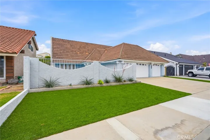 Artificial turf and updated pavers create a clean looking, low-maintenance yard