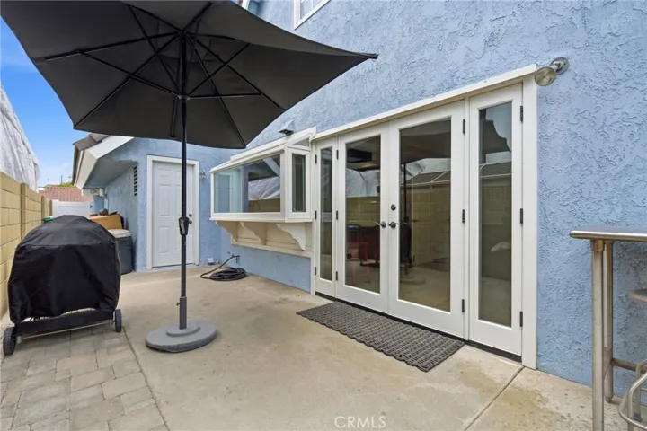 Backyard combines privacy, shade, and low-maintenance landscaping.
